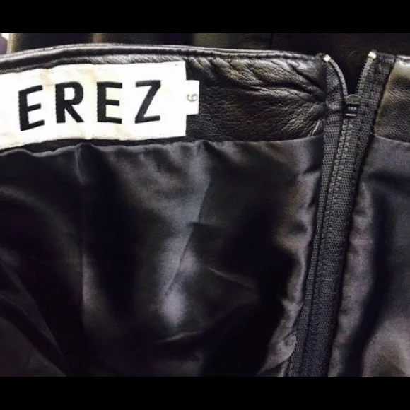 Black leather  strapless dress. 

Features a sweetheart plunge cleavage. - Picture 11 of 11